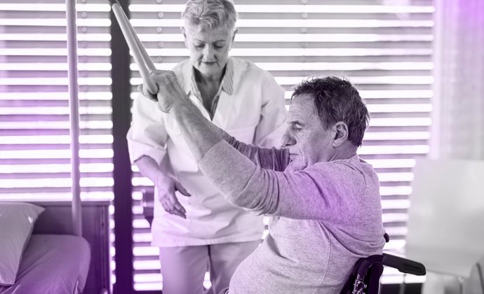 Doctor assisting patient in physical therapy session at hospice